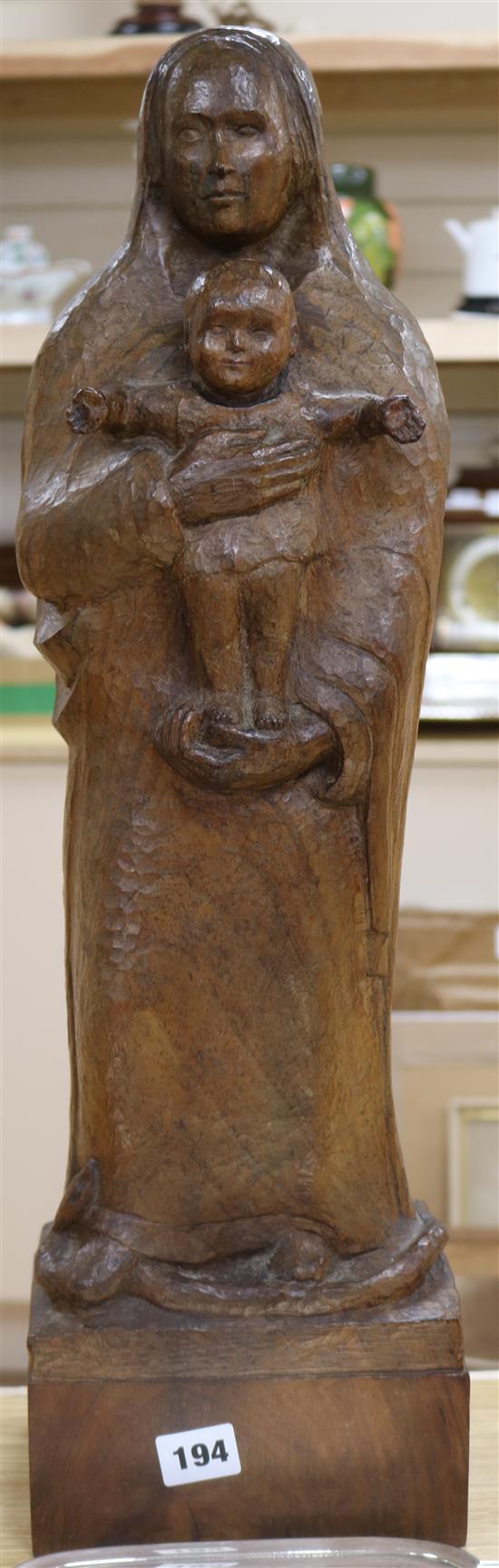 A carved wood figure of the Madonna and child height 60cm